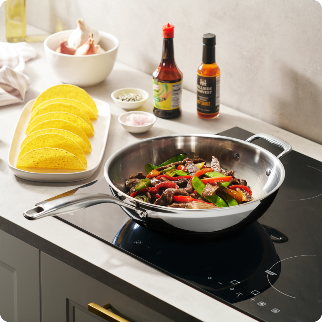 Stir-fry cooking in a Legend stainless pan on a glass cooktop