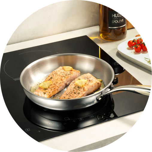 Legend pan cooking salmon on an induction cooktop