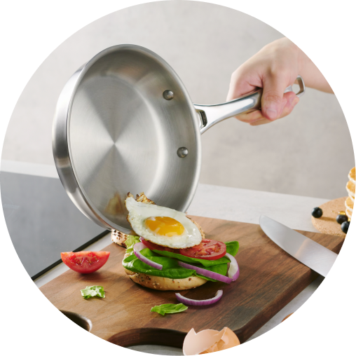 Legend pan pouring sauce over a breakfast sandwich
